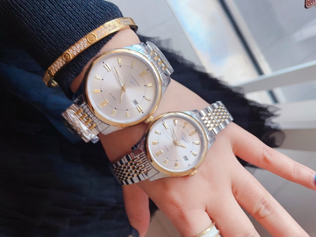 Longines wristwatch, white dial with gold accents, steel link bracelet.