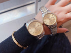 Longines wristwatch, champagne dial with steel link bracelet, worn on wrist.