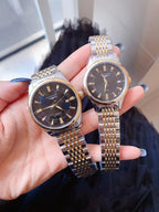 Longines wristwatch, black dial with gold hands, steel link bracelet.