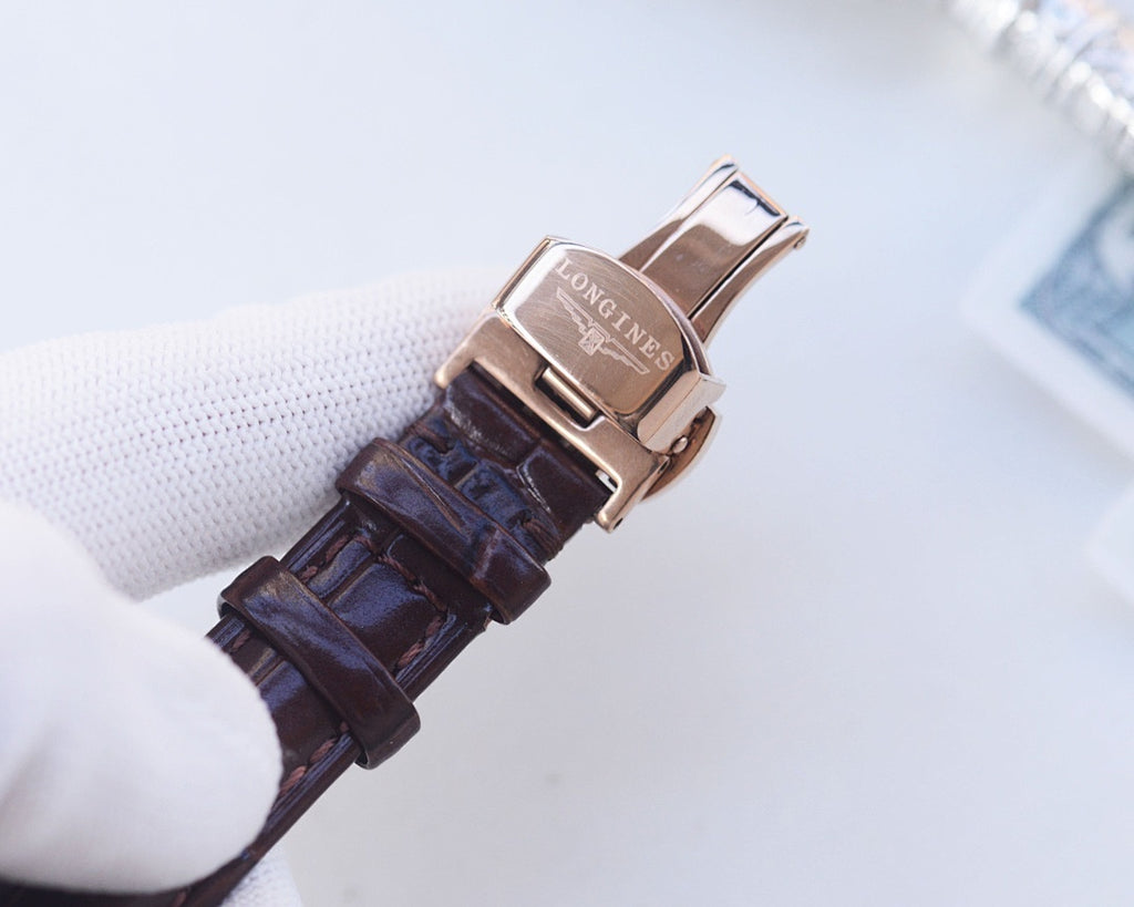 Longines wristwatch clasp view with brown leather strap and metal buckle