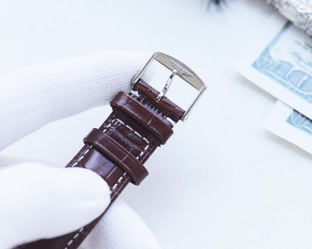 Longines wristwatch back with brown leather strap and silver buckle clasp