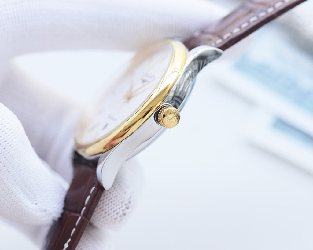Longines wristwatch crown detail, gold-toned case, brown leather strap