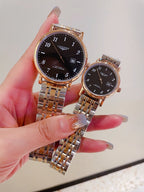 Two gold-tone and silver-tone wrist watches with dark dials and metal bracelets