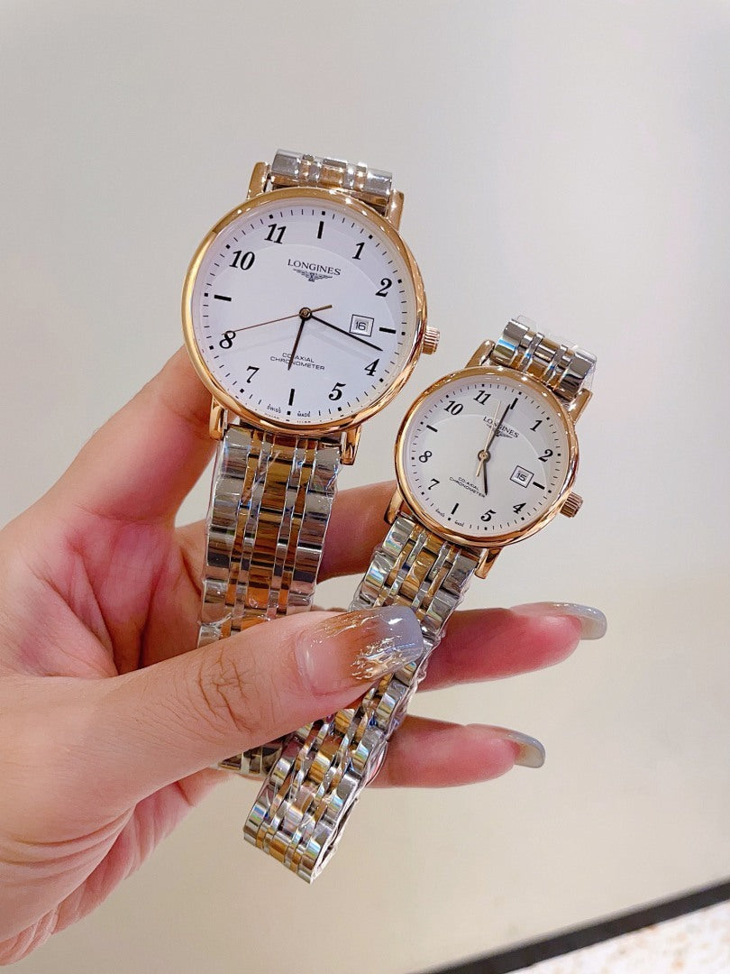 Two wrist watches with white dials and metal link bracelets held in hands