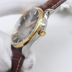 Longines watch side view, gold crown, brown leather strap with stitch detailing