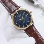 Longines watch with gold-tone bezel, navy dial, brown leather strap