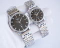 Quartz wristwatch set with dark dials and silver metal bracelets