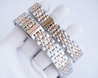 Two-tone metal bracelet watch with rose-gold bezel accents