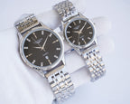 Quartz wristwatch set with dark dials and stainless steel bracelets