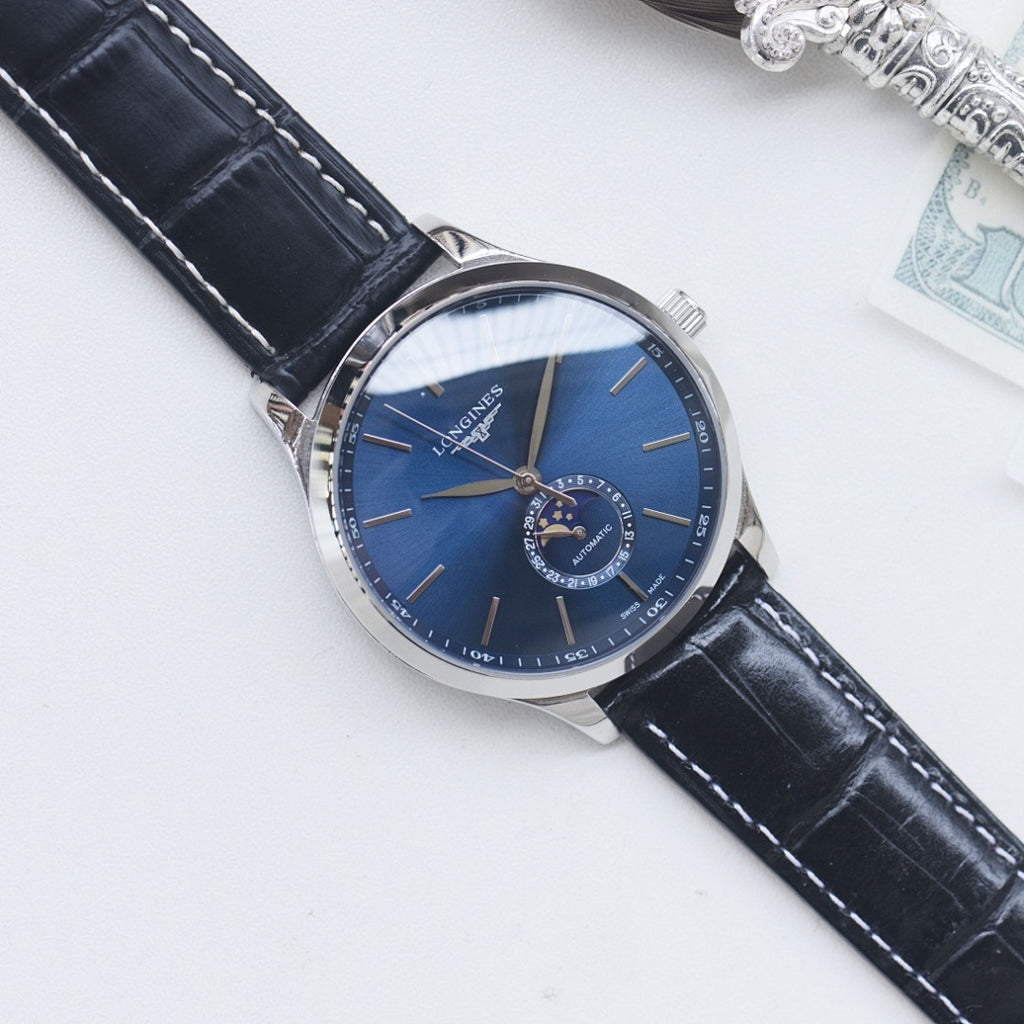 Longines watch with blue dial, silver case, and black leather strap