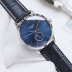 Longines watch with dark blue dial, silver case, and black leather strap