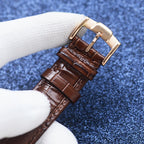 Longines watch with brown leather strap and gold-tone buckle