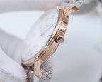 Rose-gold tone watch case with crown and linked bracelet links
