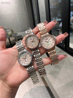 Longines watch with silver metal bracelet and light dial, worn on hand.