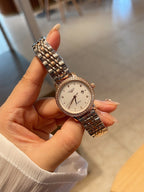 Longines watch with rose-gold tone link bracelet and round white dial with stone bezel