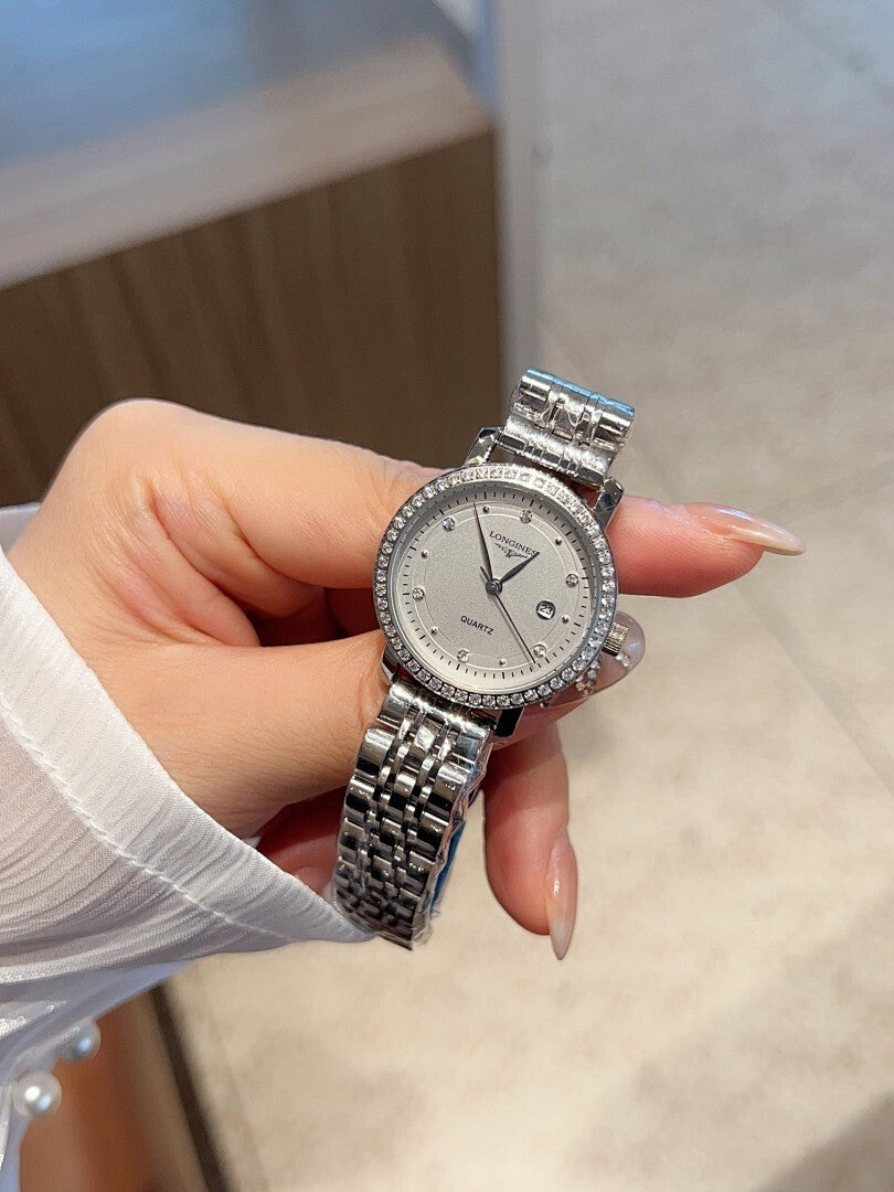 Longines watch with silver-tone link bracelet and round white dial with dark hands