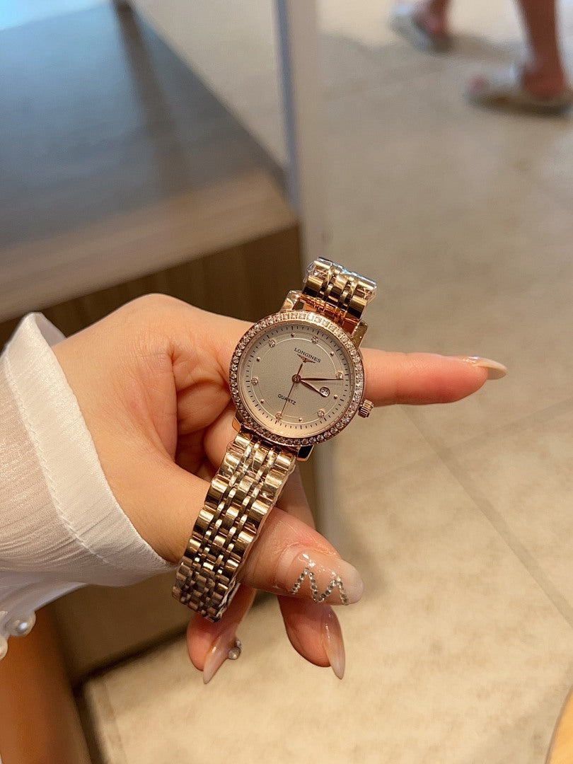 Longines watch with rose-gold tone link bracelet and round white dial with dark hands