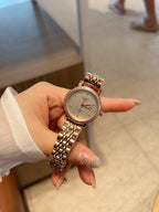 Longines watch with rose-gold tone link bracelet and round white dial with dark hands