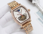 Gold-tone rectangular wristwatch with diamond bezel, light skeleton dial, red second hand.