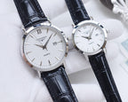 Quartz wristwatch with white dial, silver case, black leather strap