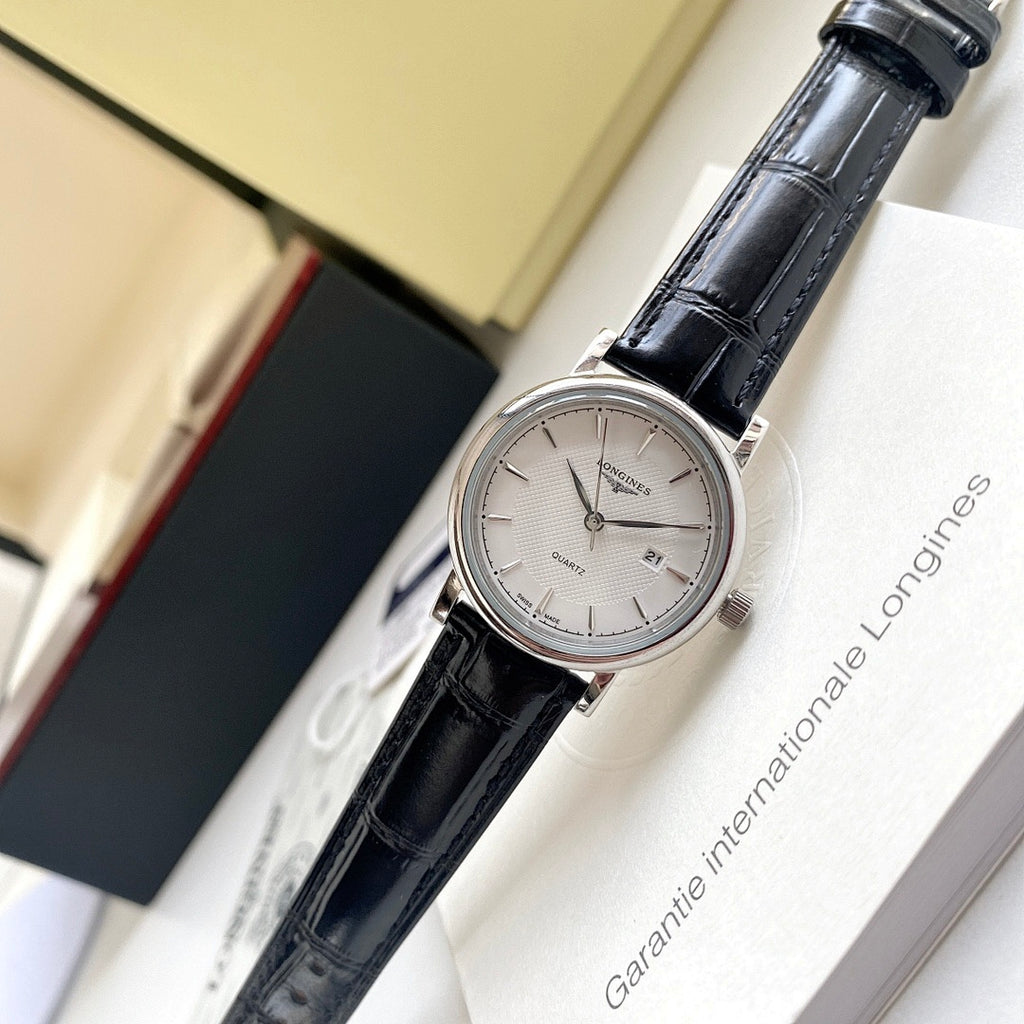 Longines wristwatch with black leather strap and silver case, white dial view