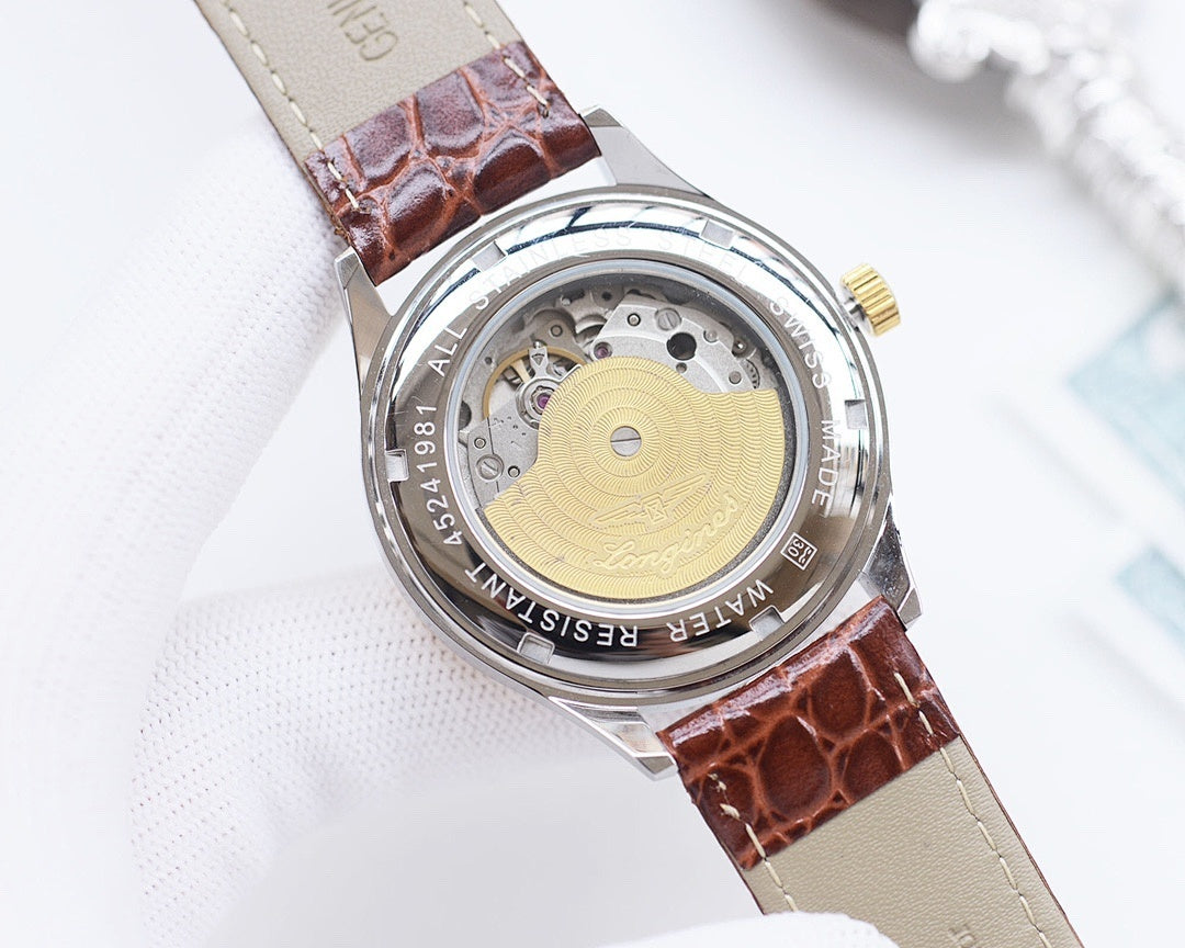 Watch caseback with exposed movement, brown leather strap and beige underside.