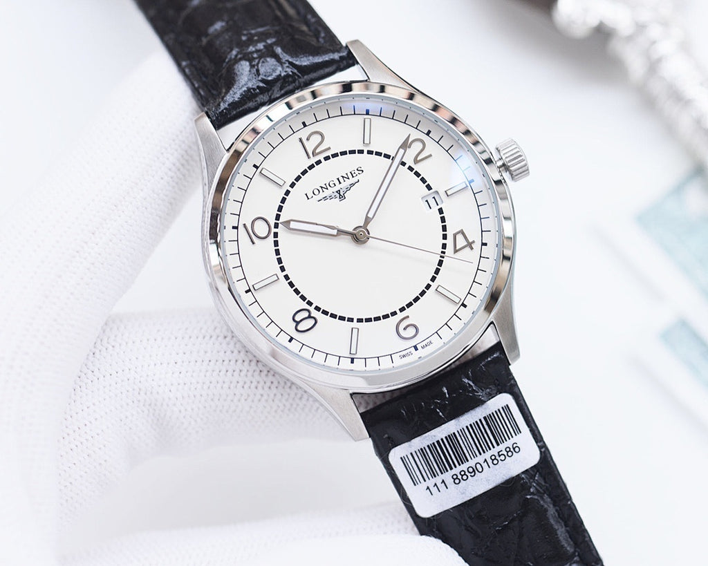 Silver analog watch with black leather strap and white dial, crown and indexes visible.