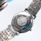 Longines watch with silver metal bracelet, case back engraved with markings.