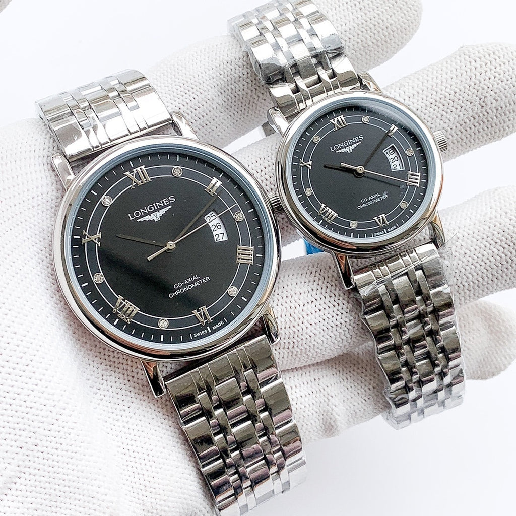 Longines watch with silver metal bracelet, dark dial, Roman numerals and date window.