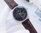Longines wristwatch with dark dial and brown leather strap, chronograph subdials