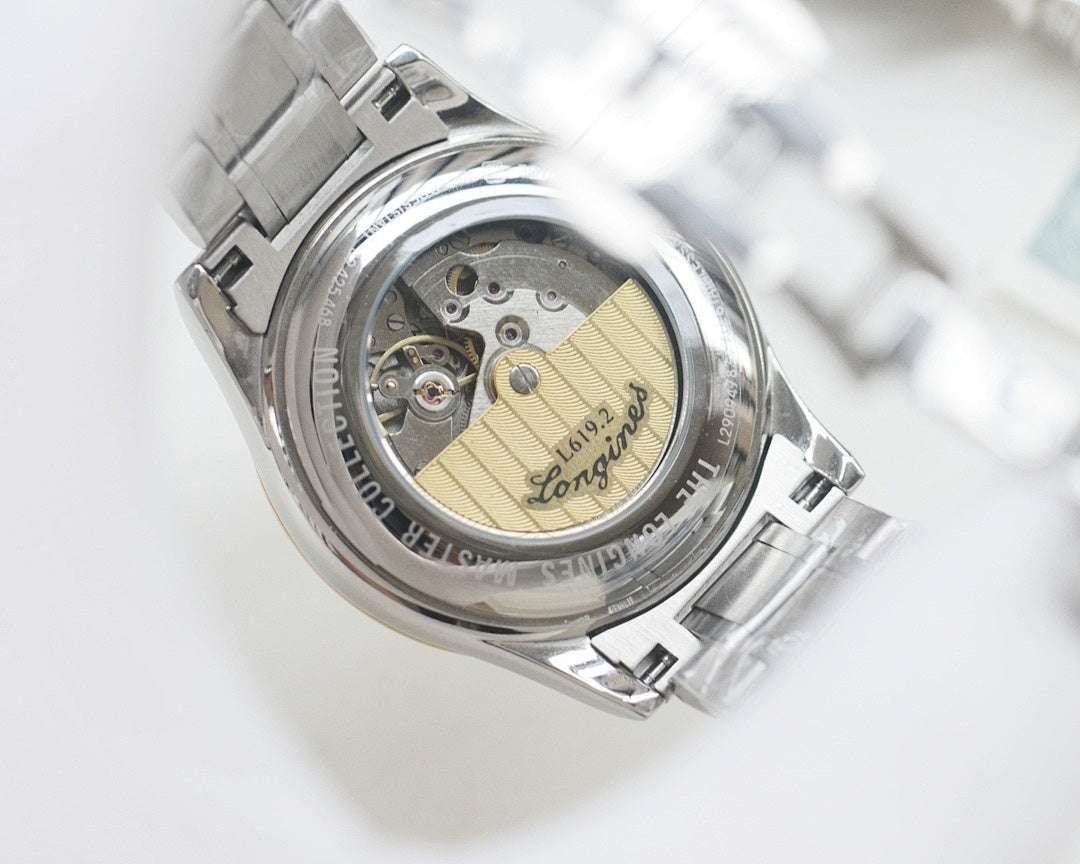 Longines wristwatch caseback with exposed mechanical movement inside silver bezel