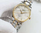 Two-tone Longines wristwatch with gold bezel, light dial, and linked steel bracelet