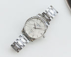 Silver Longines wristwatch with white dial and stainless steel bracelet, round face