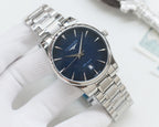 Silver Longines wristwatch with navy dial, gold-tone hands, and stainless steel bracelet