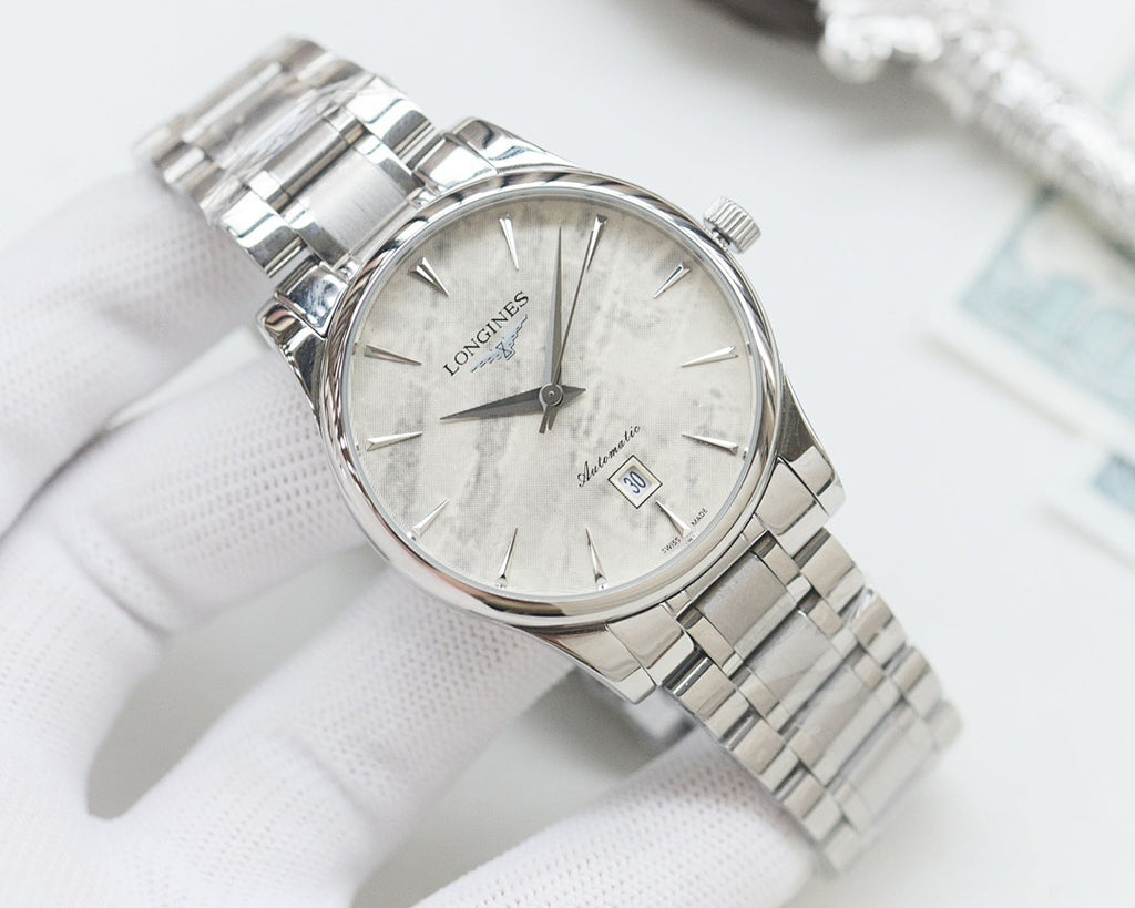 Silver Longines wristwatch with light dial and stainless steel bracelet, round case