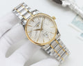Two-tone Longines wristwatch with gold bezel, white dial, and linked steel bracelet