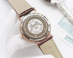 Longines watch with round engraved case, brown leather strap, and logo dial