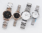 Set of four analog wristwatches with metal bracelets in dark and white dials