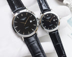 Analog wristwatch pair with black dials, silver cases, and black leather straps