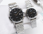 Pair of stainless-steel Longines wristwatches with black dials and metal link bands