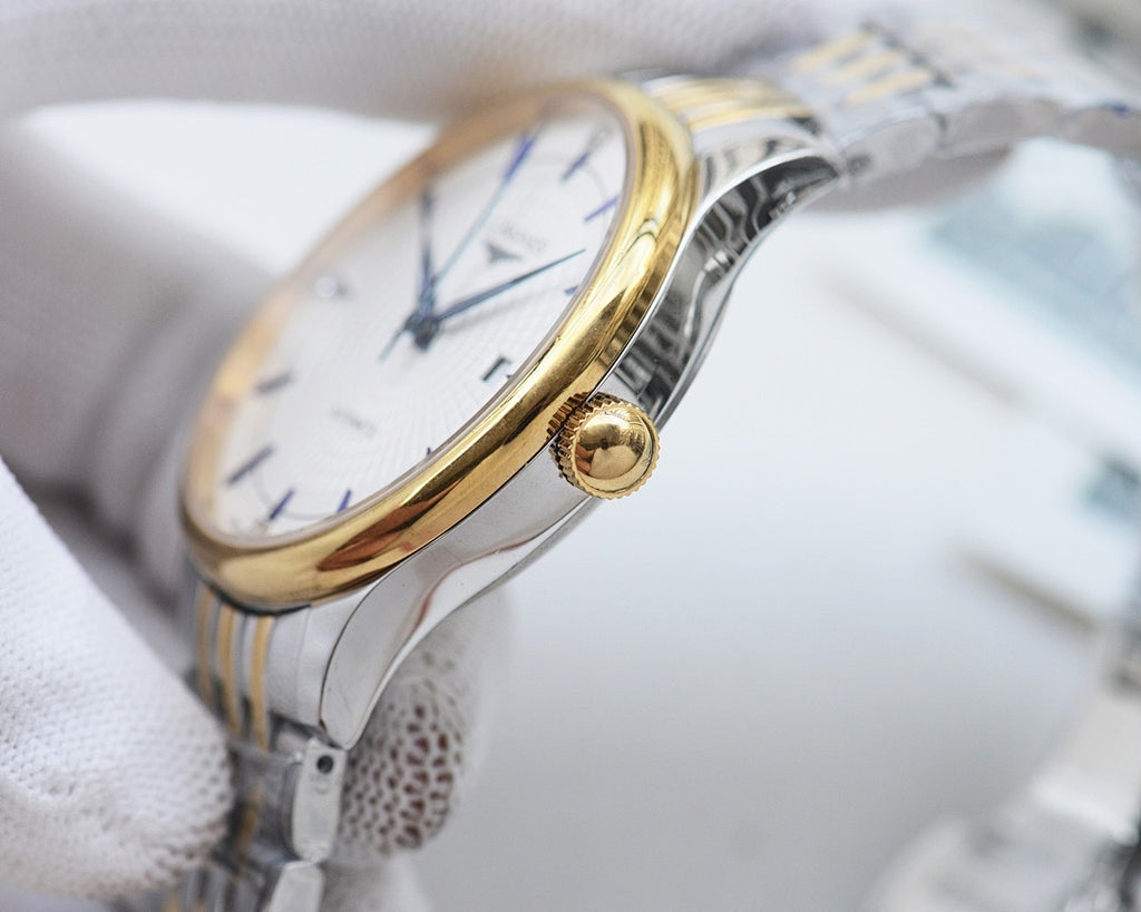 Longines automatic wristwatch with gold-toned bezel and white dial on steel strap