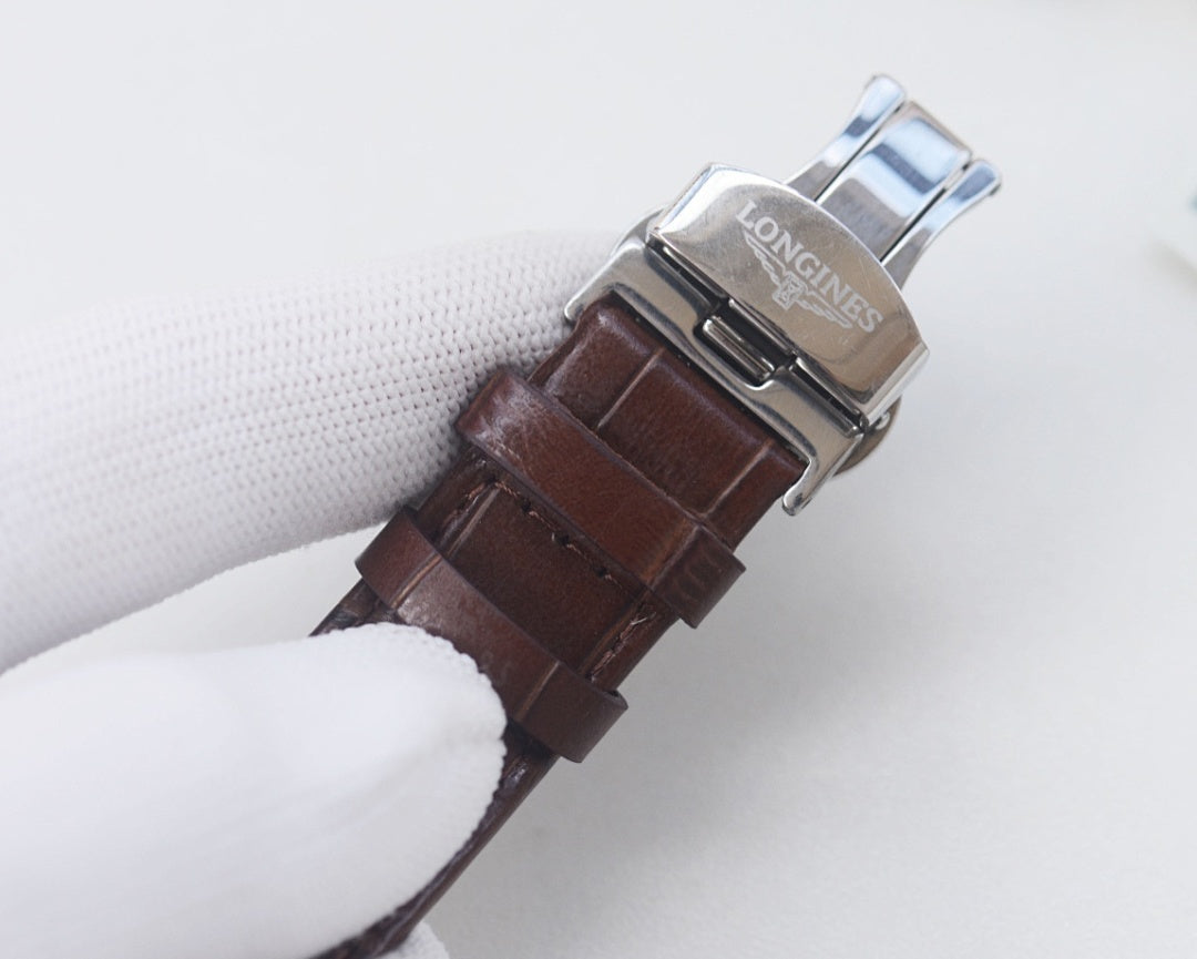 Longines wristwatch with brown leather strap and silver case, side view