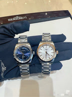 Longines wristwatch pair with silver metal bracelets: blue and white dials on display.
