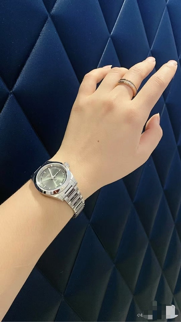 Longines watch on wrist, silver metal bracelet and dark blue dial with markers