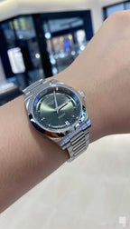 Longines watch on wrist, green dial with stainless steel bracelet and round case