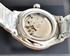 Longines watch caseback showing visible automatic movement through open back