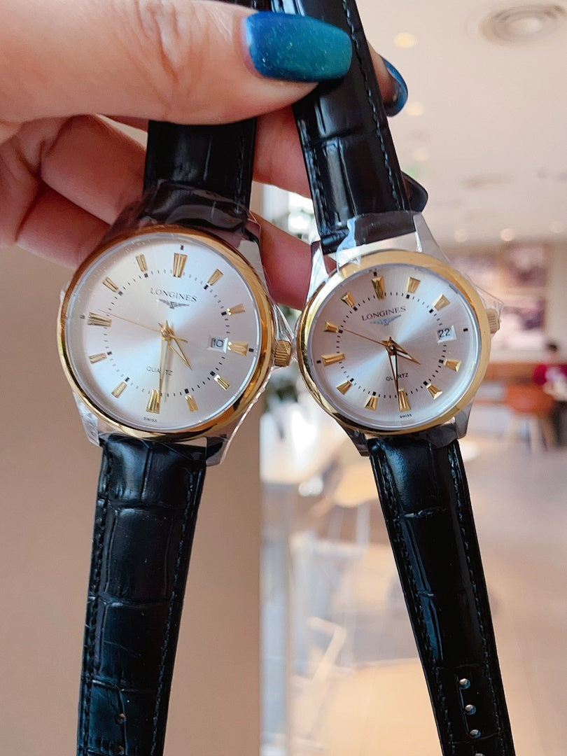 Longines watch pair with light dials and black leather straps, held up.