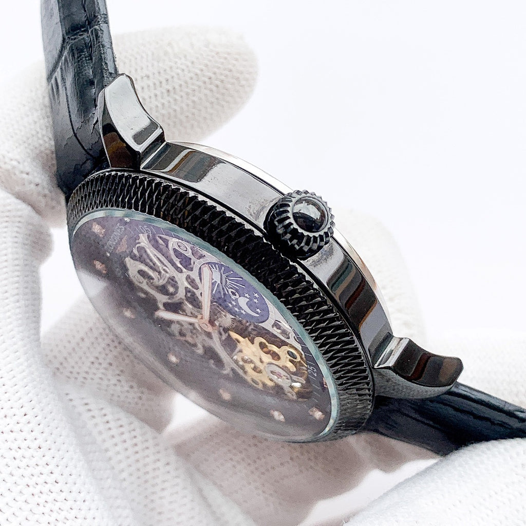 Watch side view with textured bezel and crown, blue-toned dial under glass