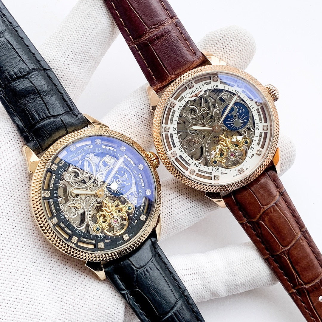 Two skeleton watches on gloves: one black strap, one brown strap with blue moon dial
