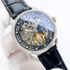 Mechanical skeleton watch with black leather strap, blue dial, silver case and gem bezel